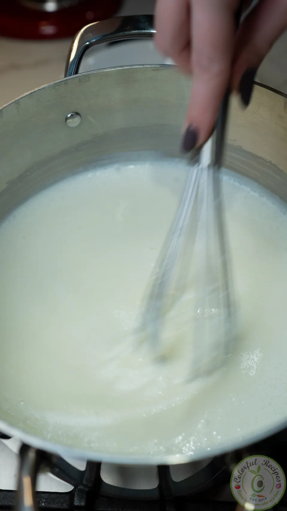 Whisking milk, semolina and sugar for ashta cream