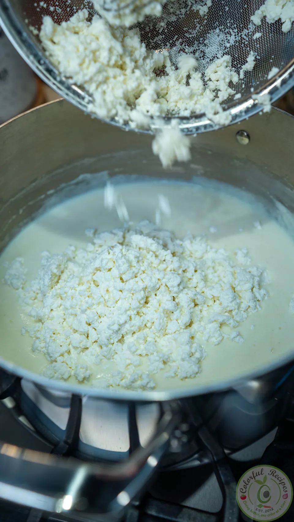 Clotted ashta crumbled into the ashta cream in a pot