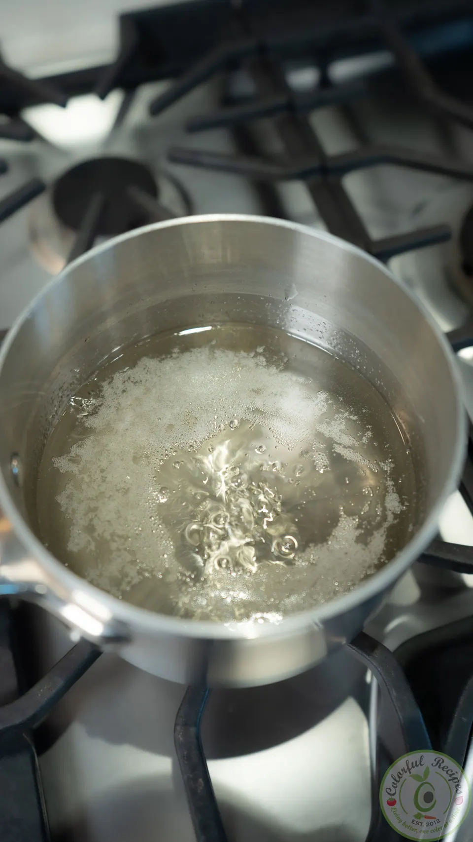 Sugar syrup simmering in a saucepan for Maamoul Mad bi Ashta