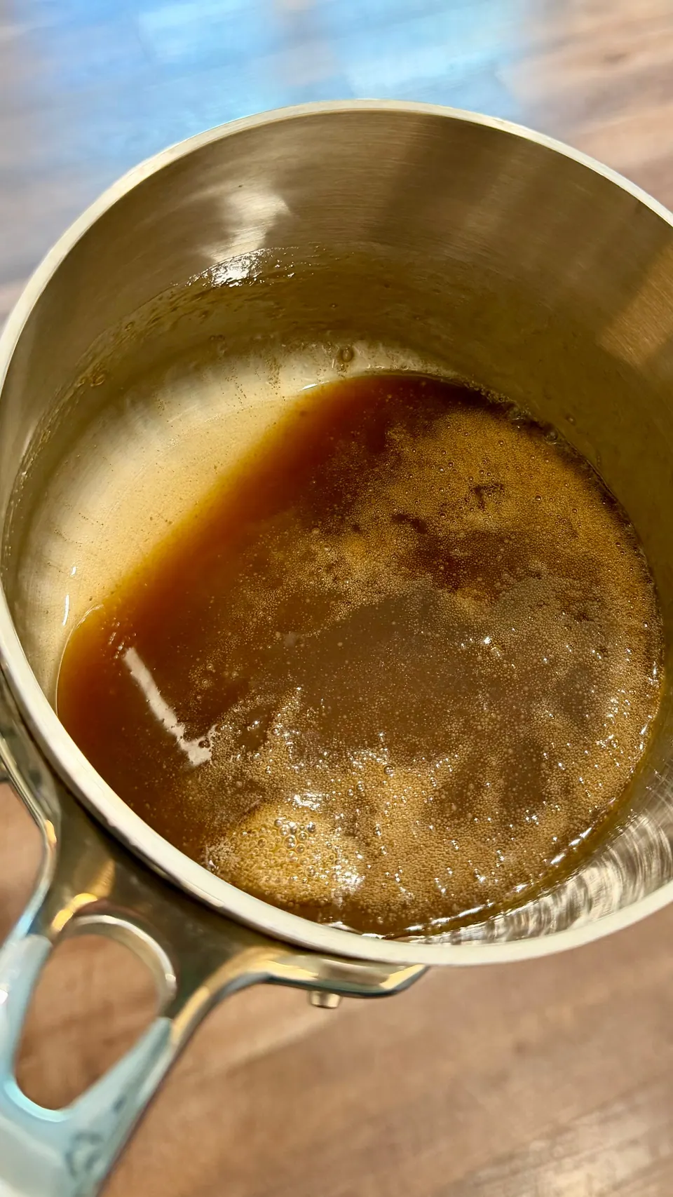 Glossy homemade bourbon caramel sauce in a saucepan