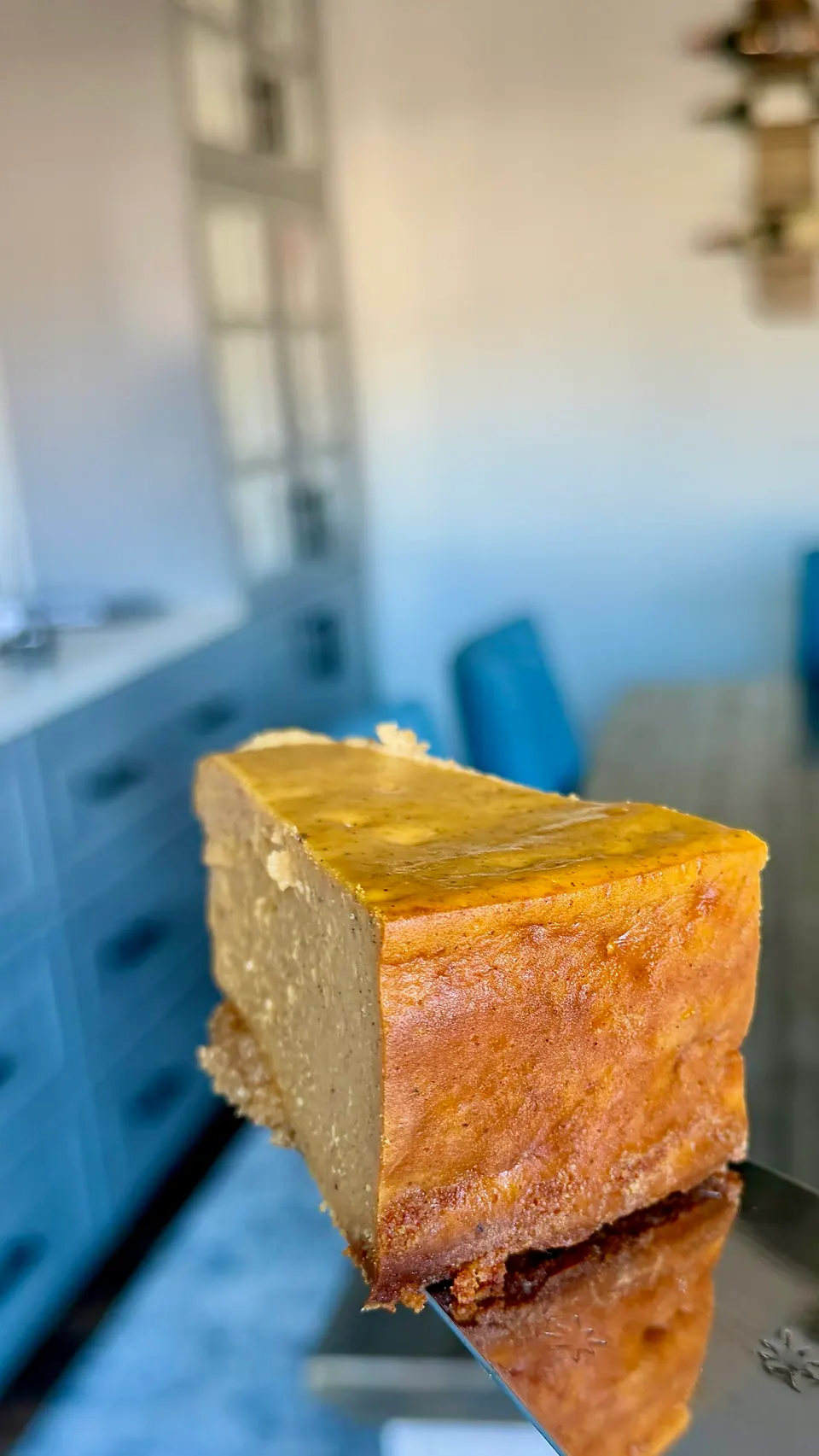 Thick slice of high-protein pumpkin pie showing the creamy filling and almond protein crust